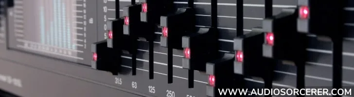 Closeup of the faders on a hardware graphic equalizer.