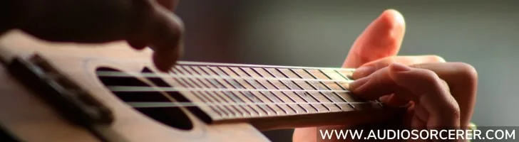 Closeup of fingers playing a ukulele in the blog article Ukulele Buddy review best ukulele lessons online.