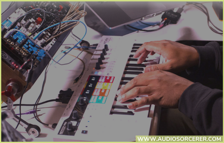 Promo picture of hands playing the Arturia KeyStep Pro MIDI controller.
