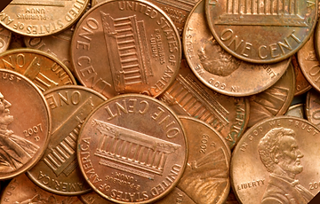 Picture of several pennies representing how much Spotify pays per stream.