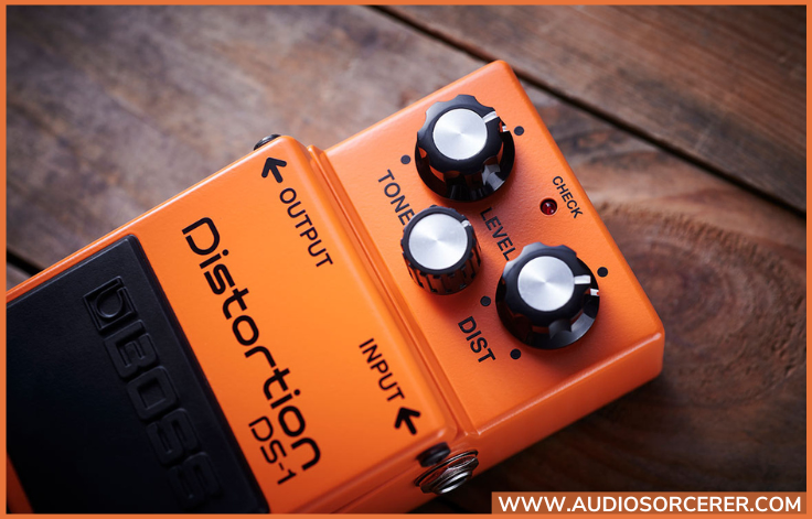 Boss DS-1 Distortion Pedal on wood floor plank.