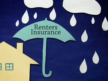 A house with an umbrella over it that says "renters insurance".