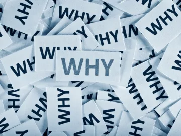 A bunch of white cards with the word "why" written on them.