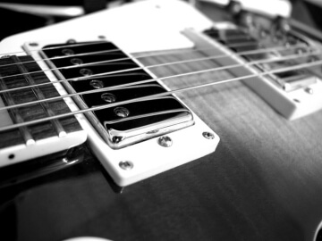 Silver humbucker guitar pickup on a Gibson Les Paul.