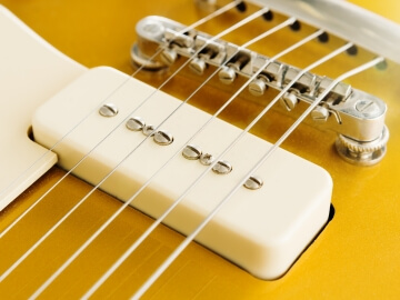 White P-90 guitar pickup.