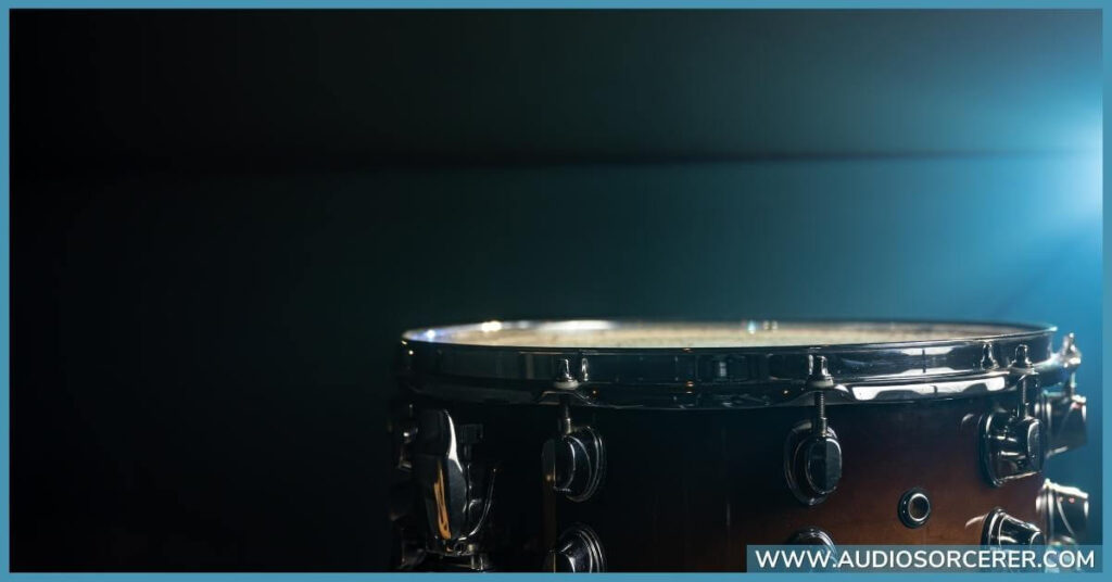 Closeup of a snare drum with a rosewood color.