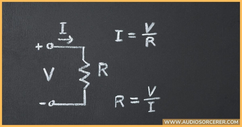 Ohm resistance formula written on a chalkboard.