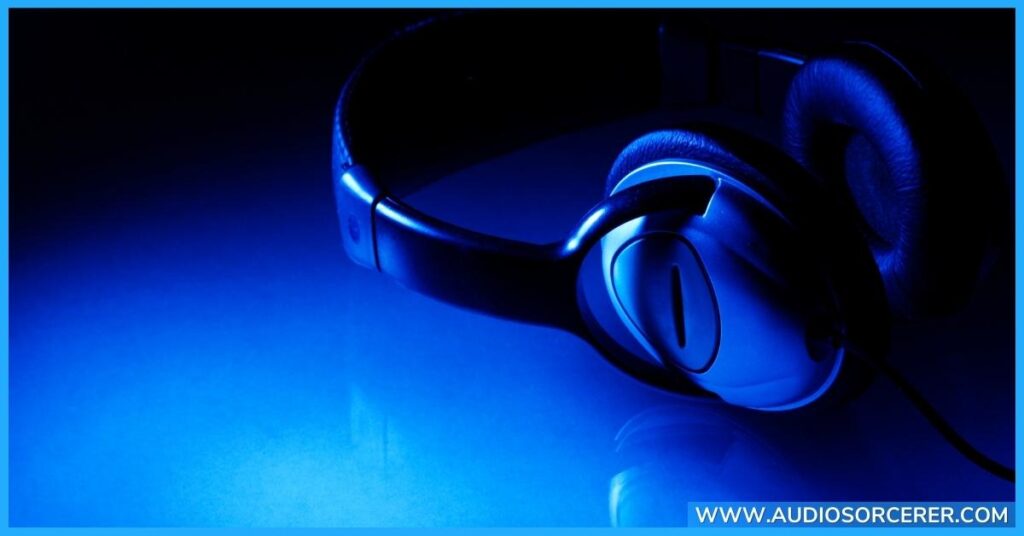 Black headphones on a blue table.