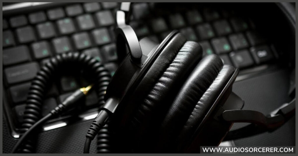 Sony wired headphones sitting on a keyboard.