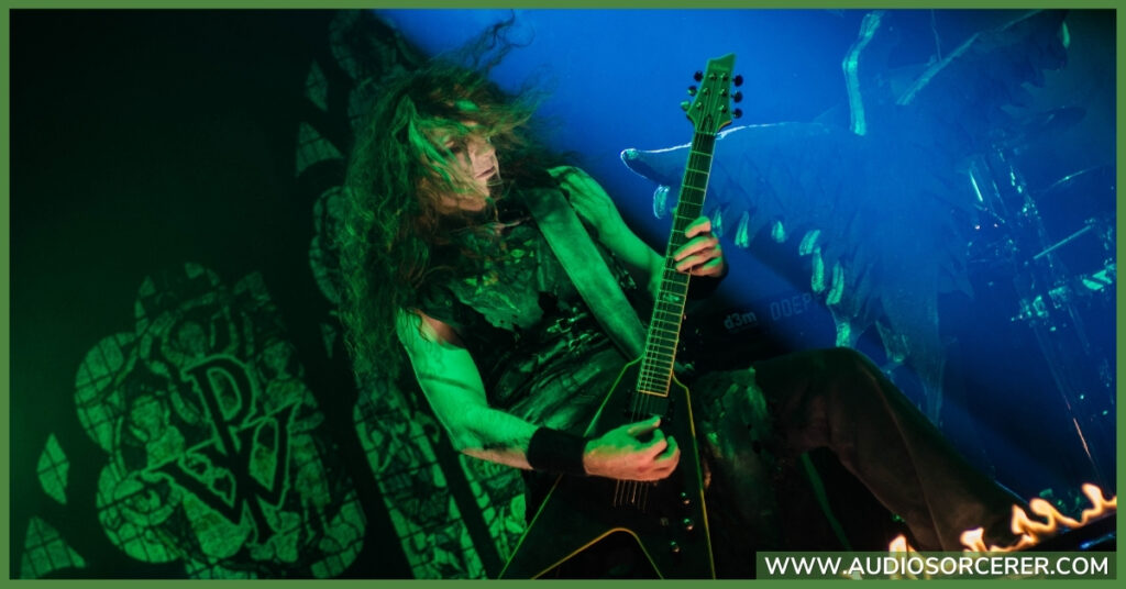 Rock guitarist playing a solo on stage.