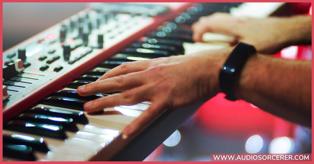A man playing chords on a keyboard.