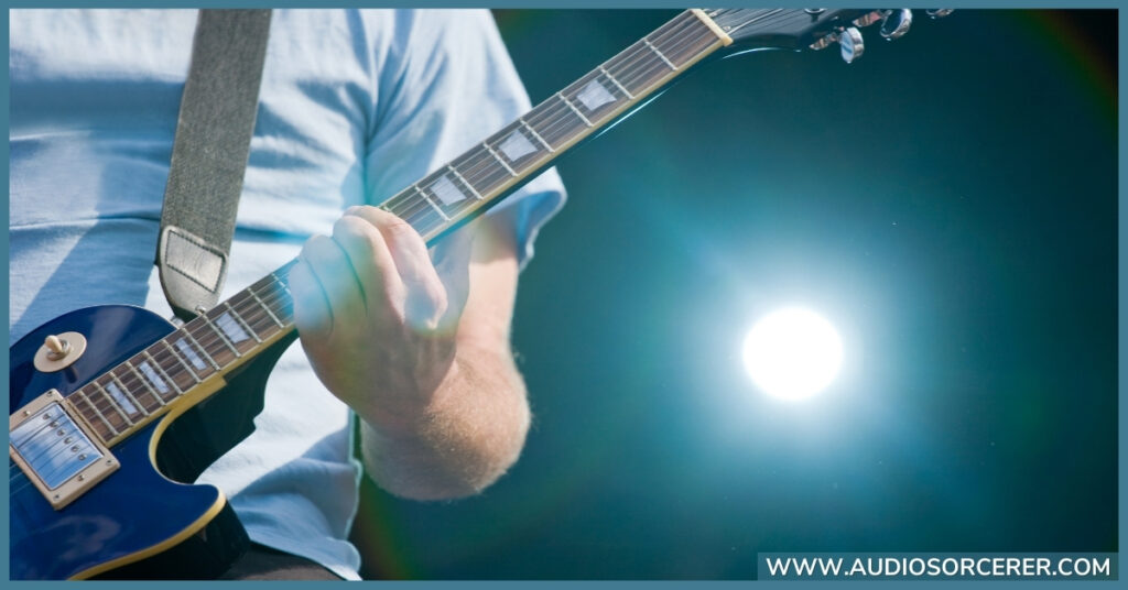 Man playing a Les Paul guitar live.