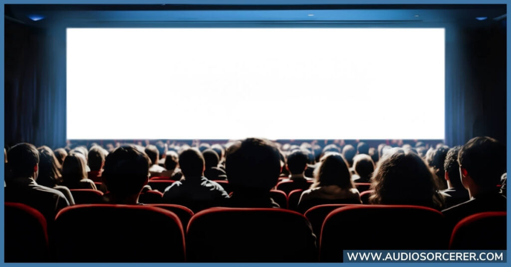 A movie theater with a white screen with Dolby Atmos.