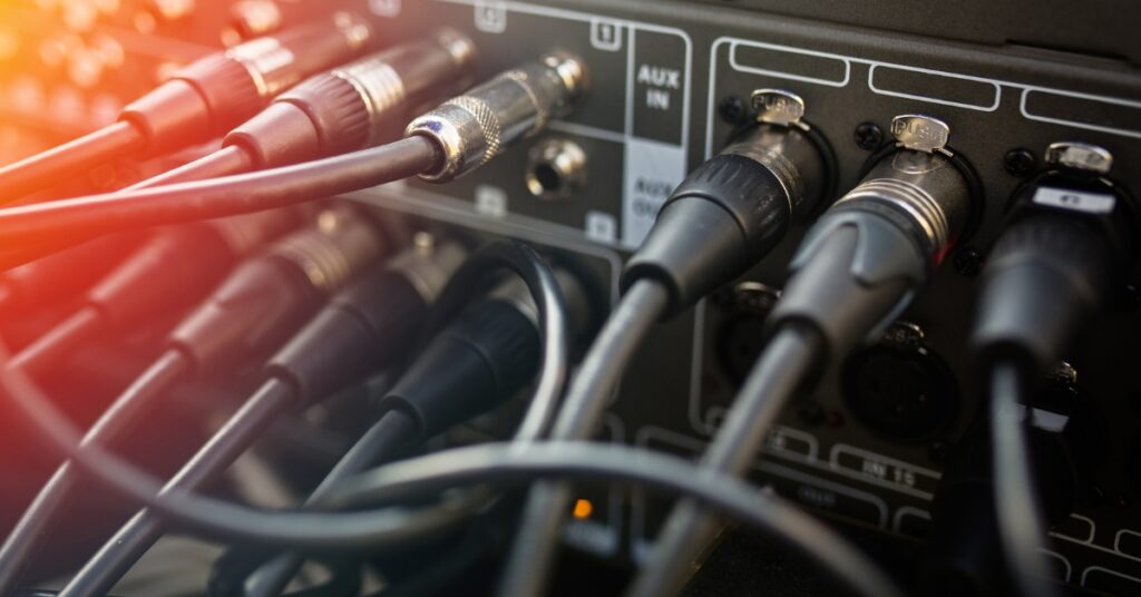 cables connected to a mixing board.